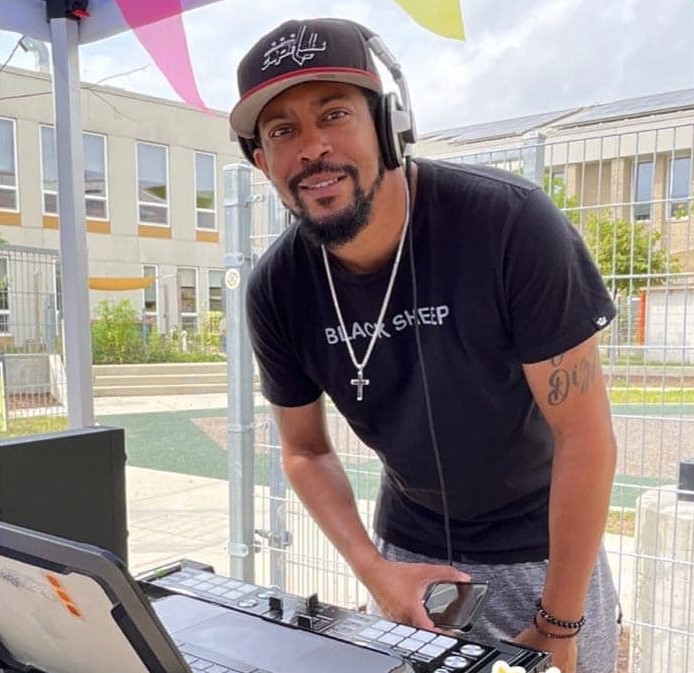 A man DJs at an outdoor event.
